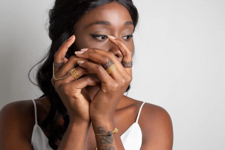 black model displaying a stacked and a slave ring in black and gold